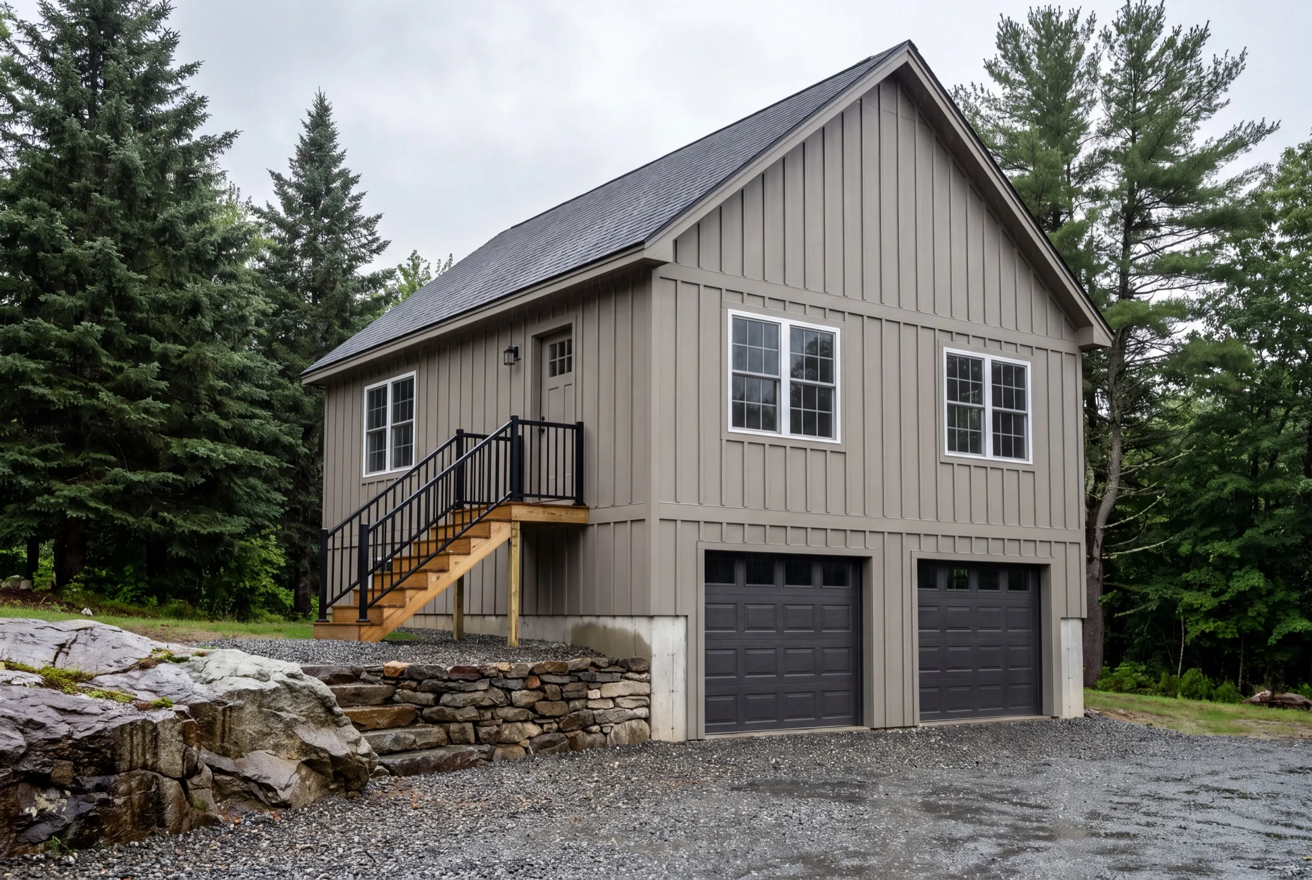 ADU builder Vassalboro Maine: finished gray board and batten two-bay garage with an apartment and side stair