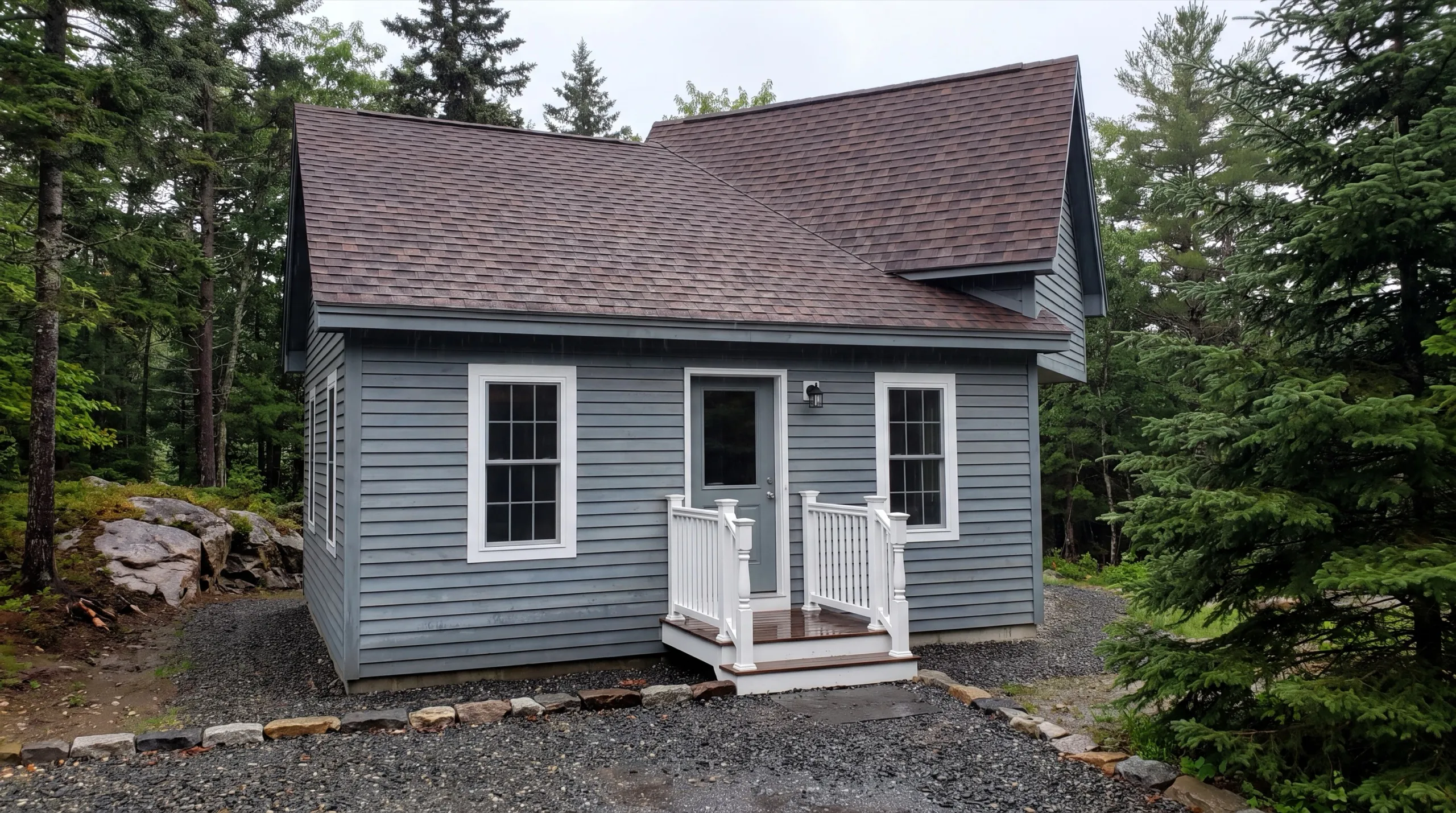 ADU builder in Wiscasset, ME: finished small gray cottage with a brown roof and a small entry deck