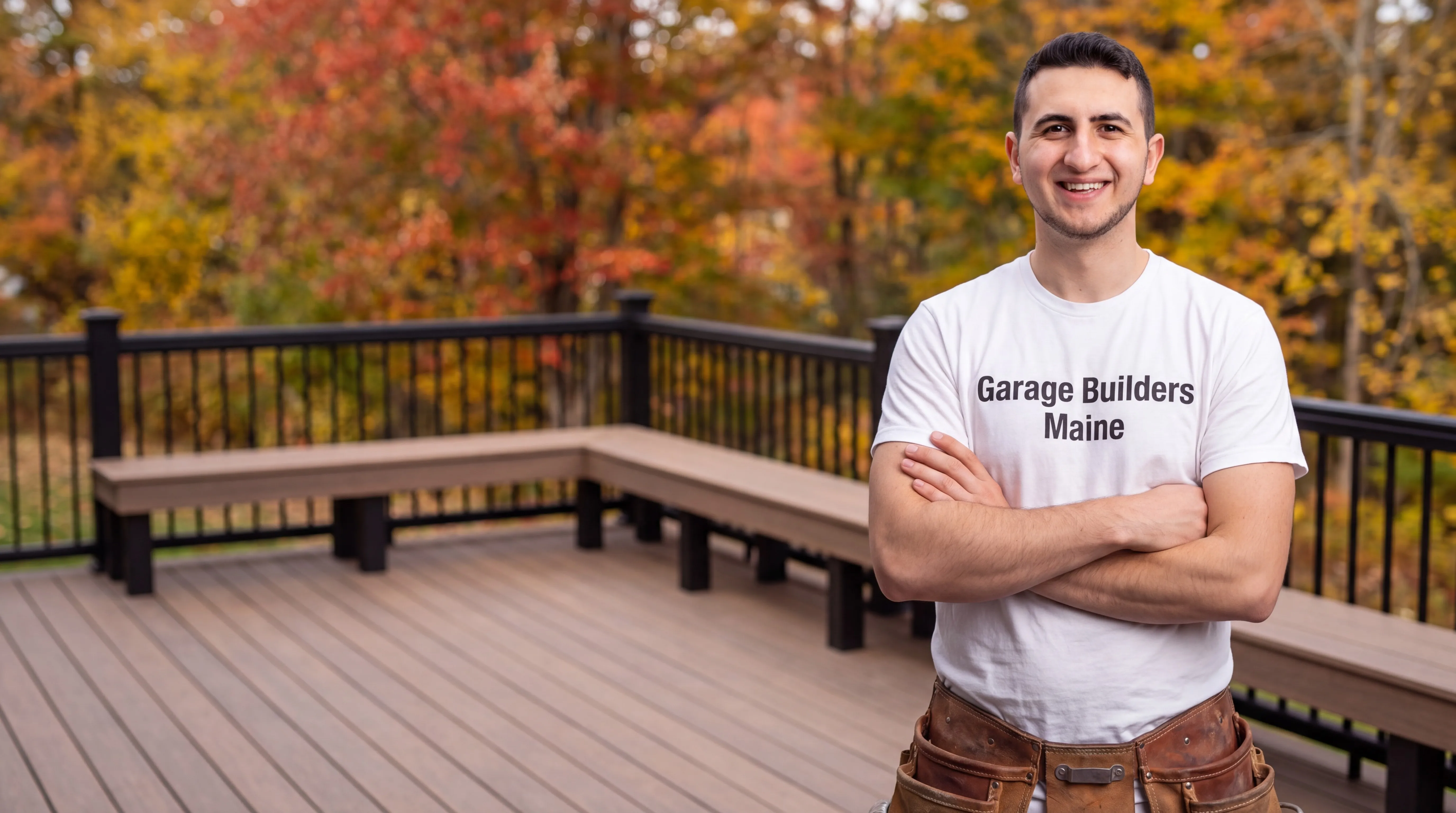 Owner of Garage Builders Maine standing with his arms crossed and smiling at a Maine job site
