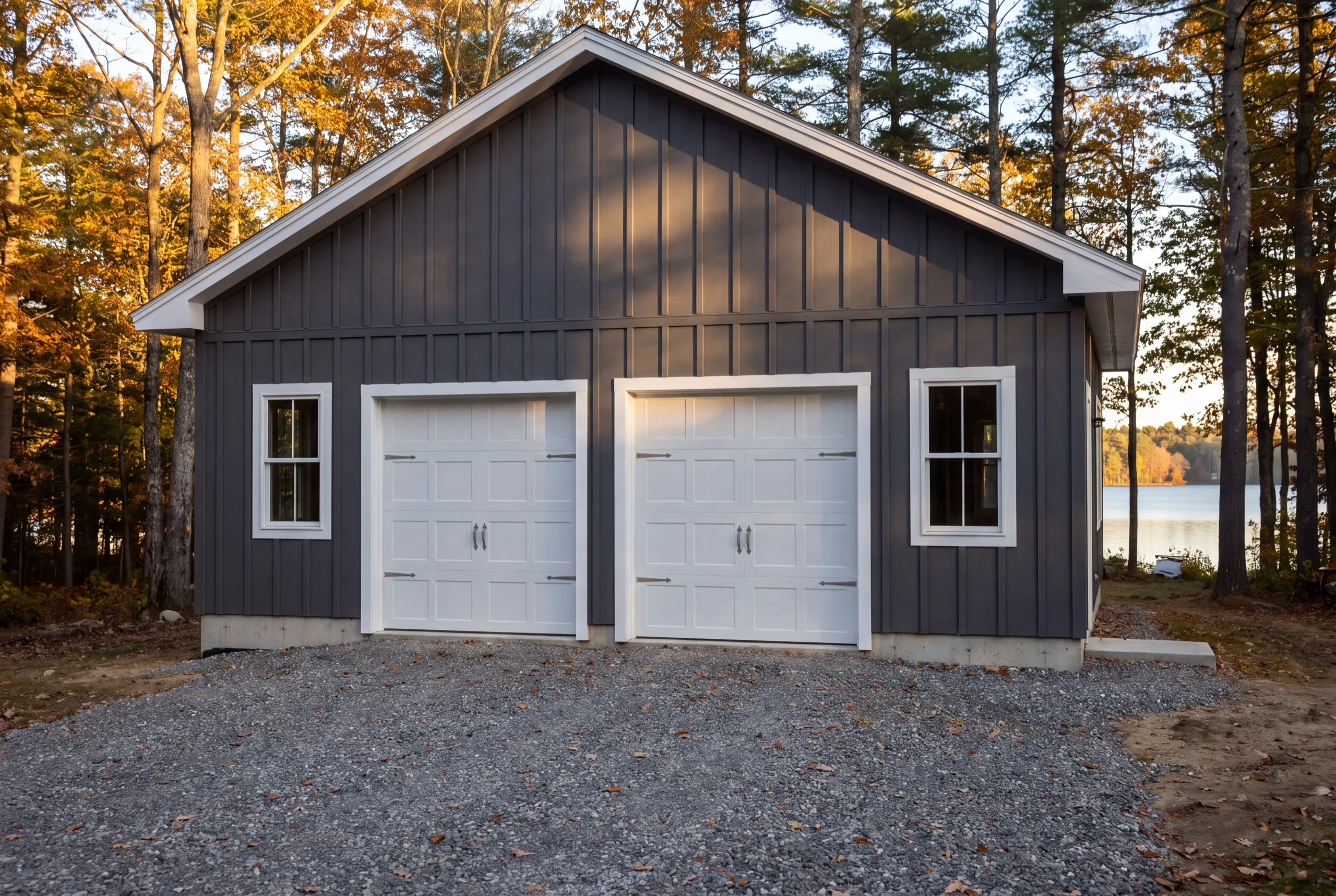 Detached garage builder Manchester Maine: finished charcoal board and batten two-bay garage with white carriage doors