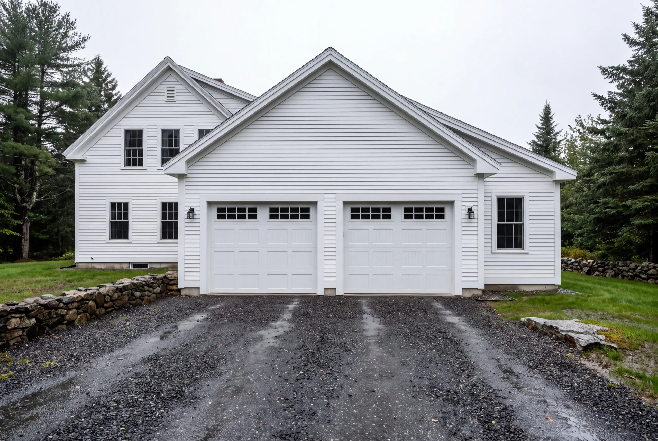 Garage builders Windsor Maine: white two-bay front-gable garage attached to a two-story white house