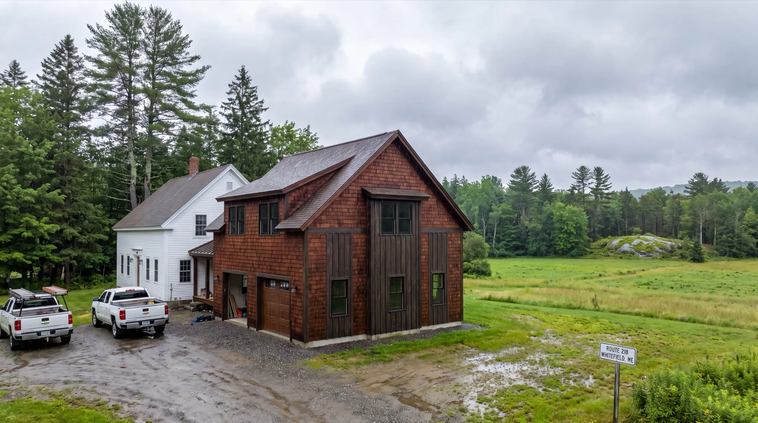 general contractor in Whitefield, ME reviewing plans on farmland