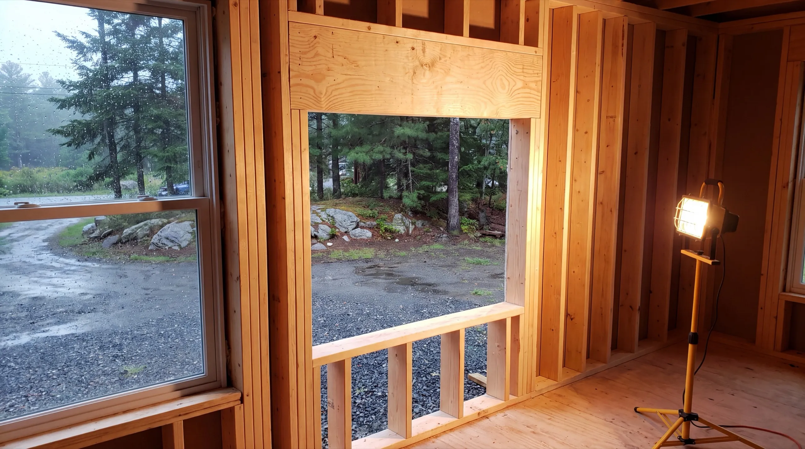 Home remodeling contractor Vassalboro Maine: framed wall with a new header over a window opening and a work light
