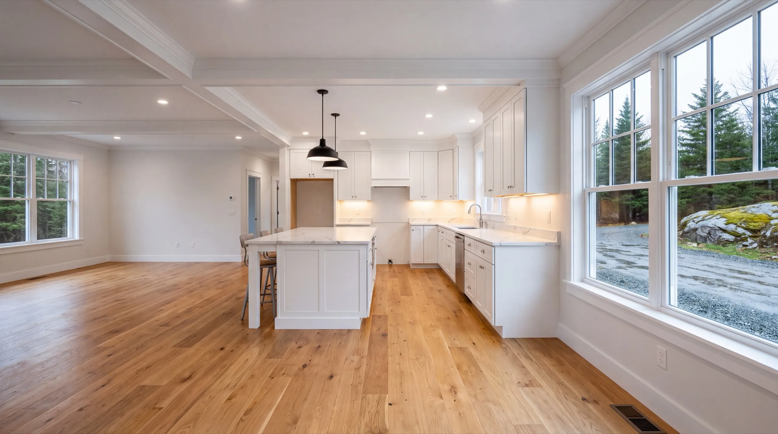 Remodeling in West Gardiner, ME: finished open kitchen with an island, coffered ceiling and wide windows